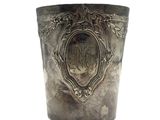 a silver cup with a design on it on a white background