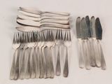 a lot of forks and spoons that are on the table