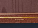 a close up of a brown suitcase on a table