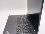 a laptop that is sitting on a white surface