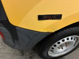 a close up of a yellow car with a sticker on it
