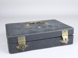 a gray suitcase that is sitting on a white surface