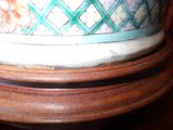a close up of a vase on a wooden table