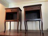 two nightstands sitting on a wooden table in a room