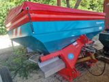 a red and blue boat sitting on a trailer