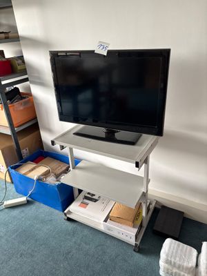 a flat screen tv sitting on a stand in the corner of a room
