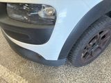 a close up of the front of a white car