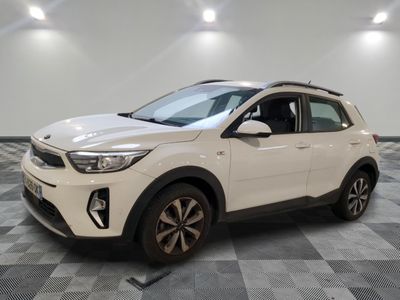 a white car is parked in a room with a checkered floor
