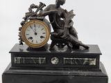 a clock sitting on top of a table next to a pair of scissors