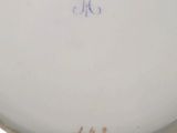 an antique porcelain plate with a blue and white design on it