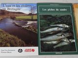 two books on a table with a river in the background
