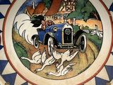 a plate with a picture of a dog and a car on it