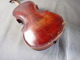 an old violin sitting on top of a sheet of paper