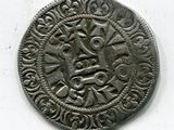 une pièce d'argent sur laquelle figure un motif