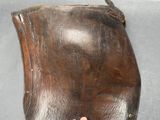 a hand that is holding a brown leather purse