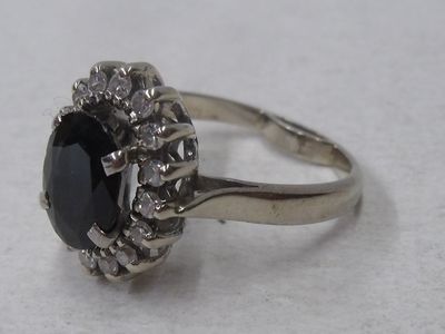 Bague en or blanc 18K, sertie d’un saphir ovale entouré de 1…