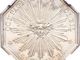 an image of a silver coin with a sunburst in the center