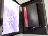 a black case with a red book inside of it