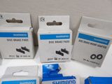 four boxes of shimano disc brake pads on a table