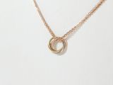 a gold necklace with a circle pendant on a chain