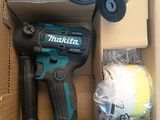 a box with a cordless drill and other tools in it