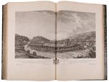 an open book with a picture of a town in the middle of it