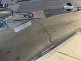 a close up of a car door with a license plate on it