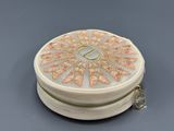 cream and gold round box with flower design and zipper closure