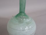 a green vase that is sitting on a table