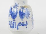 a blue and white vase with two birds on it