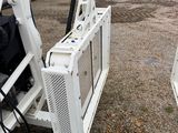 a white machine that is sitting in the dirt