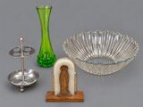 a green vase, a green glass bowl, a silver plate, and a green glass candle holder