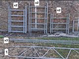 six metal frames with numbers on them in front of a brick wall