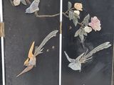 a black screen with birds and flowers on it