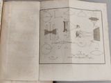 an open book with drawings on it on a table