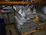 many stacks of metal items on a pallet in a warehouse
