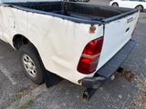 a white pick up truck parked in a parking lot