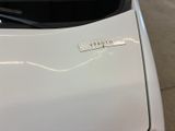 a sticker on the hood of a white car