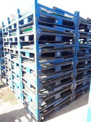 many pallets stacked on top of each other on the ground