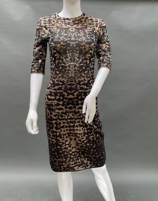 a mannequin wearing a leopard print dress and hat