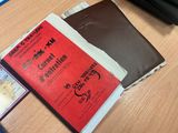 two books sitting on a table next to a wallet