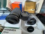 many cameras sitting on a table with boxes of other items