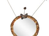 an image of a round mirror with a flower decoration on it