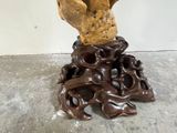 a statue of a hand holding a piece of wood
