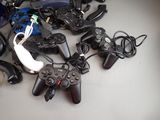 a pile of video game controllers sitting on a table
