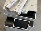 a stack of three printers sitting on top of each other