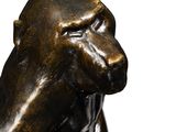 a statue of a monkey that is sitting on top of a table