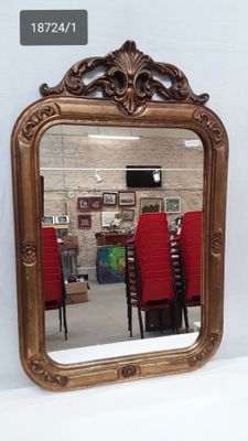 a mirror that is sitting on a table in a room