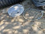 a metal manhole cover and a metal grate on the ground