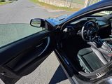 a black car with its door open on the street